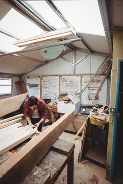 Man working on wooden plank