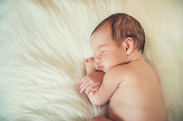 Sleeping newborn baby on a blanket