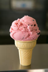 Black Cherry yogurt cone on countertop of ice cream shop