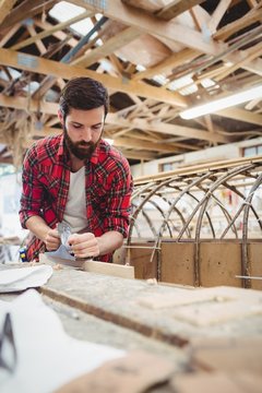 Man preparing wooden boat frame