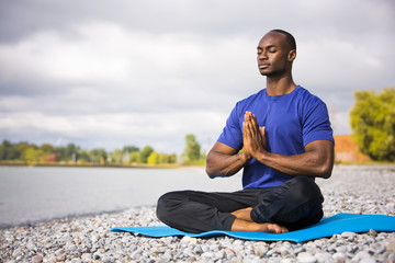 Fototapeta na wymiar young man exercising yoga