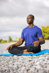 Fototapeta na wymiar young man exercising yoga