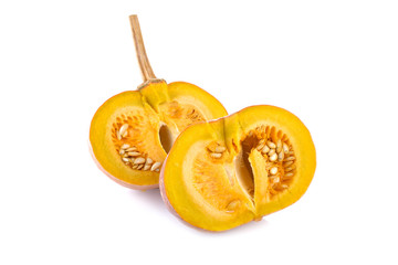 half cut pumpkin with seeds and stem on white background