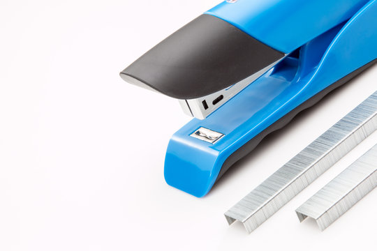 Blue stapler with staples on a white background.