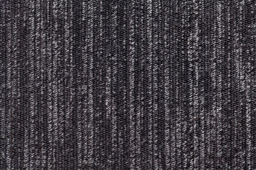 Black and white background of a knitted textile material. Fabric with a striped texture closeup.