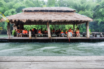 Fototapeta na wymiar Wood plank gray on blurred scene tourist floating raft green jungle in sai yok river kwai