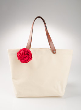 bag or shopping handbag with rose on background.