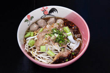 Rice noodle soup with Stewed beef with thai style on black wood