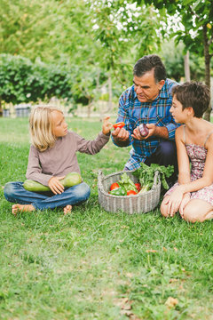 Grandfather Teaching Healthy Eating to Grandchildren