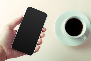 smartphone and coffee on the table