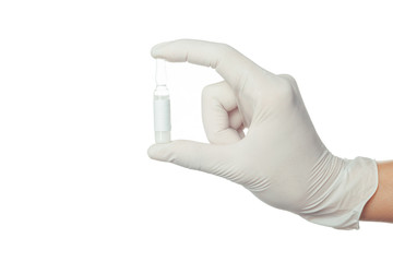 doctor's hand in white sterilized surgical glove holding medicine