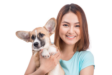 Young asian woman with a little puppy isolated over a white back