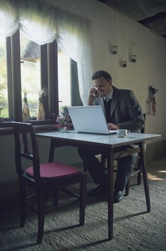 Businessman is Working with Mobile Phone and Laptop