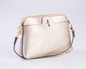 bag or gold colour handbag on background.