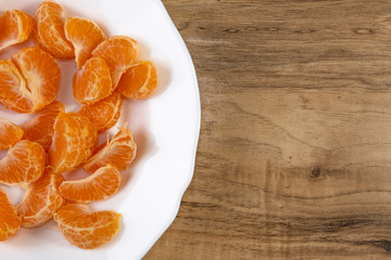 Naklejka na ściany i meble fresh tangerine slices on a white plate