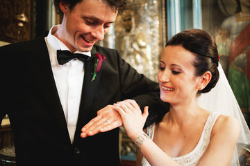 Newlyweds with rings in church