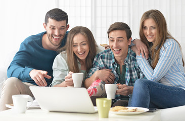 happy friends and  laptop