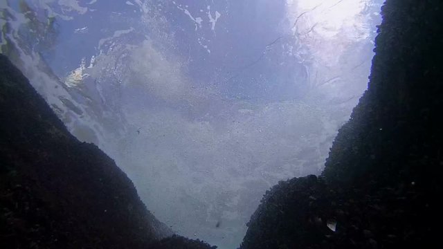 The waves rolled through coastal cliffs, the view from the bottom up.
