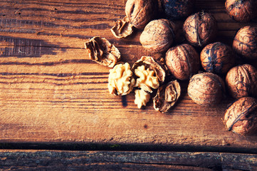 Walnuts on wooden background. Copyspace