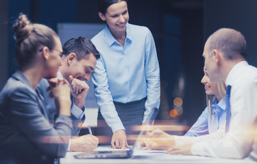 smiling female boss talking to business team