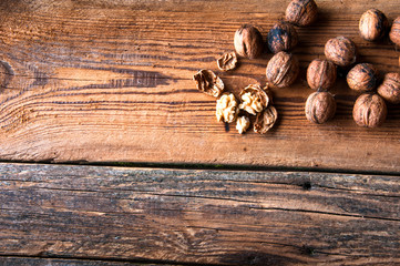 Walnuts on wooden background. Copyspace