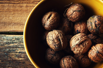 Walnuts on wooden background. Copyspace