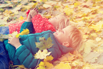 cute little boy and girl playing in autumn fall