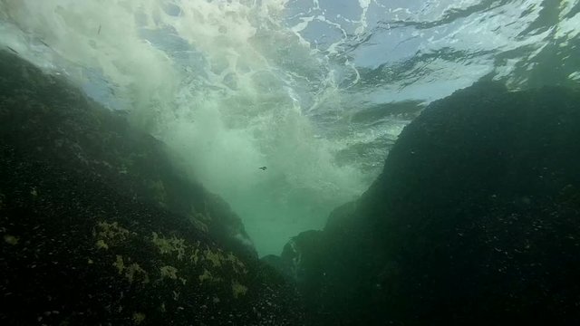 The waves rolled through coastal cliffs forming whirlpools.
