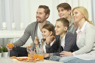family at home with pizza