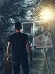 Man walking toward the haunted house