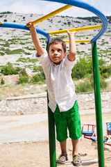 Obraz premium Boy playing on jungle gym