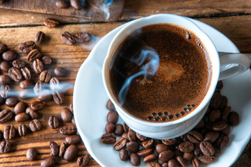 Steaming coffee with freshly ground beans. Top view. Copyspace