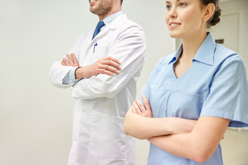 close up of doctor and nurse at hospital corridor