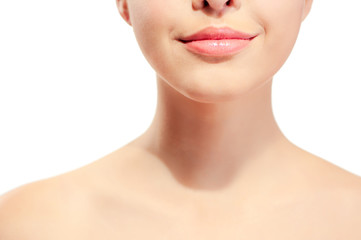 Closeup of young woman's pink lips and neck against white background
