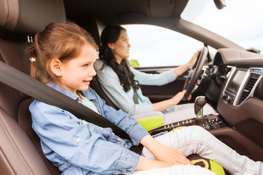 Happy Woman With Little Child Driving In Car