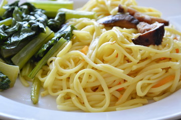 stir fried vegetarian noodle with mushroom and Chinese cabbage on dish