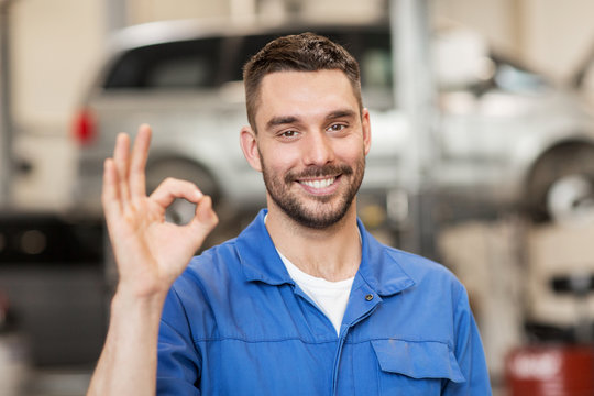 auto mechanic or smith showing ok at car workshop