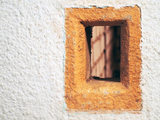 small window in a whitewashed wall