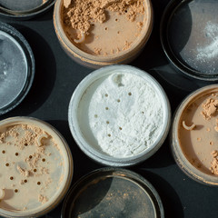 Square background with mineral make-up powder of white, nude and beige colors for facial care