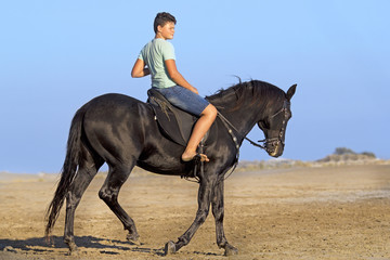 young rider on the beach