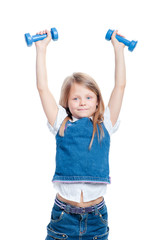 Super strong kid. Pretty little girl raised up dumbbells. Isolated on white.