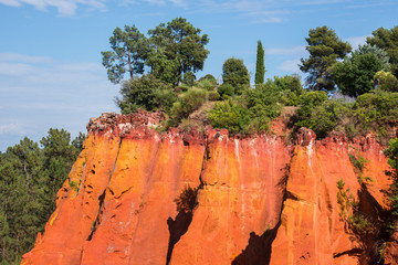 Reddish rock formations made of ocher near Roussillon village, Provence, France