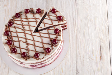 Chocolate cake with mousse, decorated cherries