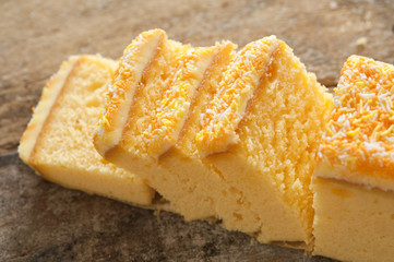 Close up of yellow cake with sprinkles and icing