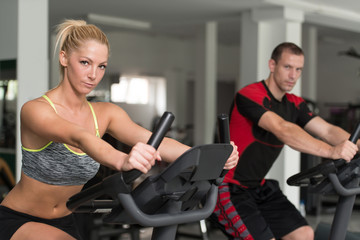 Healthy People On Bicycle In Fitness Gym