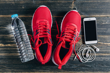 Fitness concept, Essential running item, Overhead view of running shoe, water, smartphone and earphone