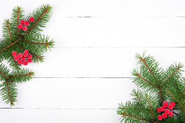 Christmas tree branch with decorations on white wooden table. Christmas background