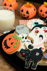 Creepy Halloween cookies next to a milk glass
