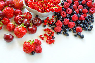 Strawberries dropped on the white surface.