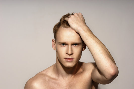 Studio Fashion Style Closeup Face Portrait Of Young Emotional Man Holding His Red Hair With His Hand